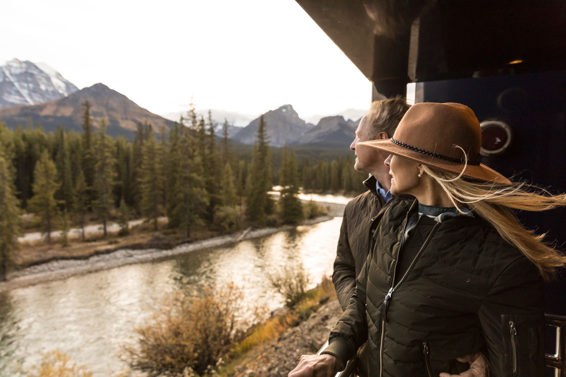 Traveler enjoying the outdoor viewing platform aboard Rocky Mountaineer