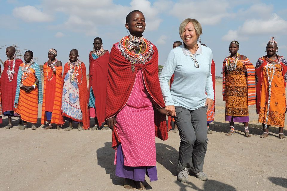 A Tauck traveler sharing a cultural experience in Kenya