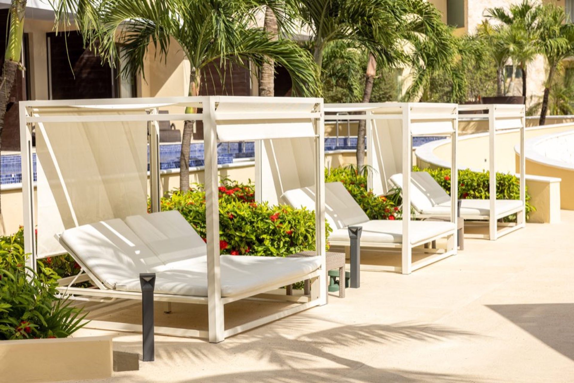 Private loungers beside a Royalton Hideaway pool