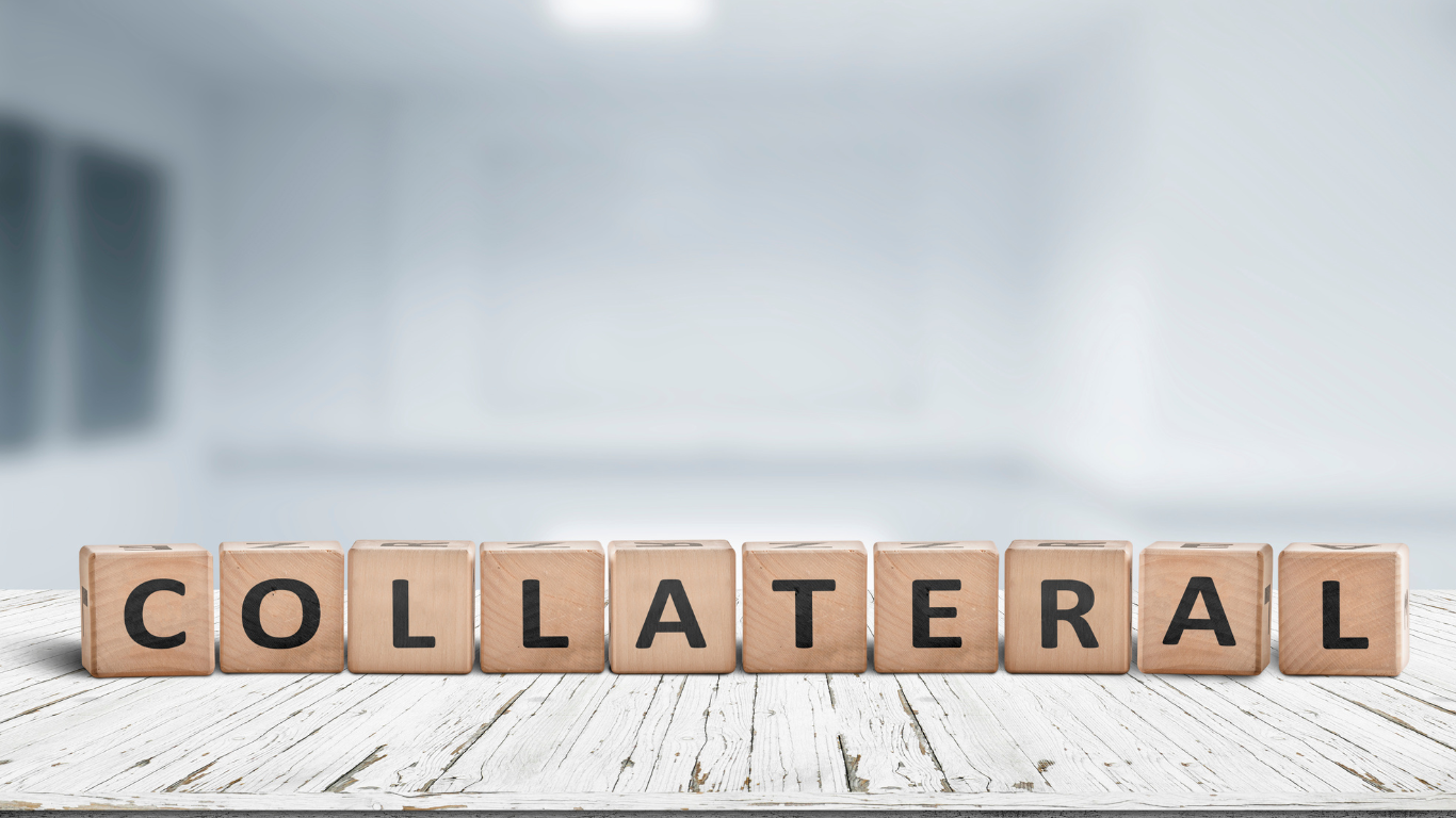 The word collateral is written on wooden blocks on a table.