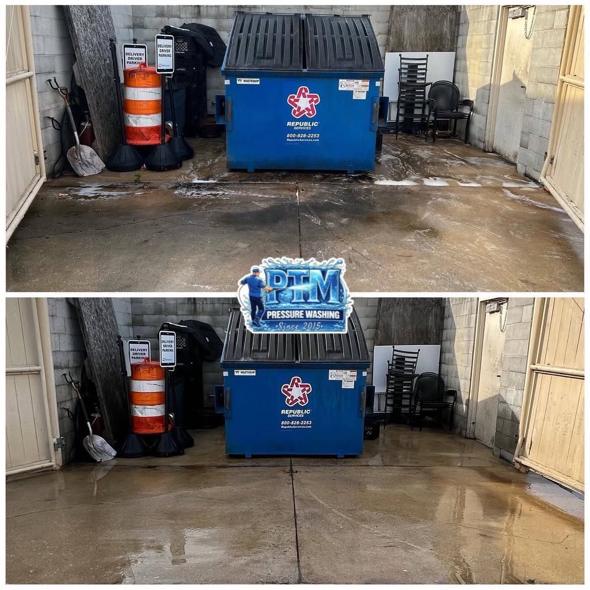 Two dumpster bins in a narrow alley, with orange cones and wet pavement.