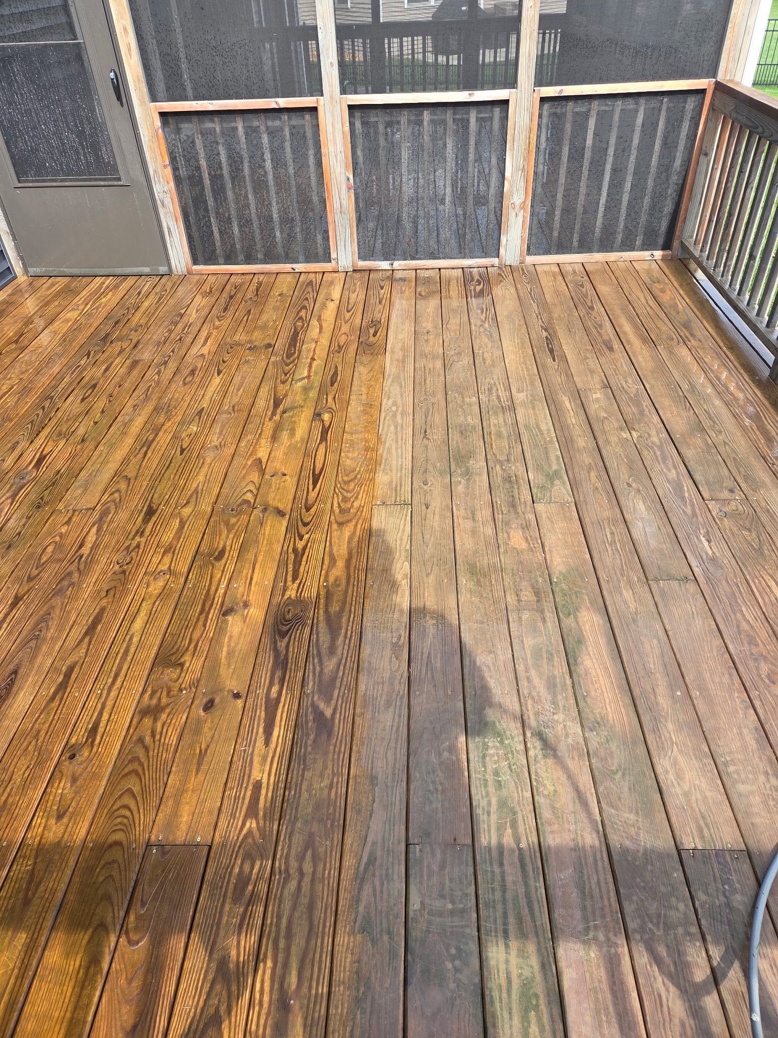 Wooden deck boards with one freshly stained section beside an unfinished section