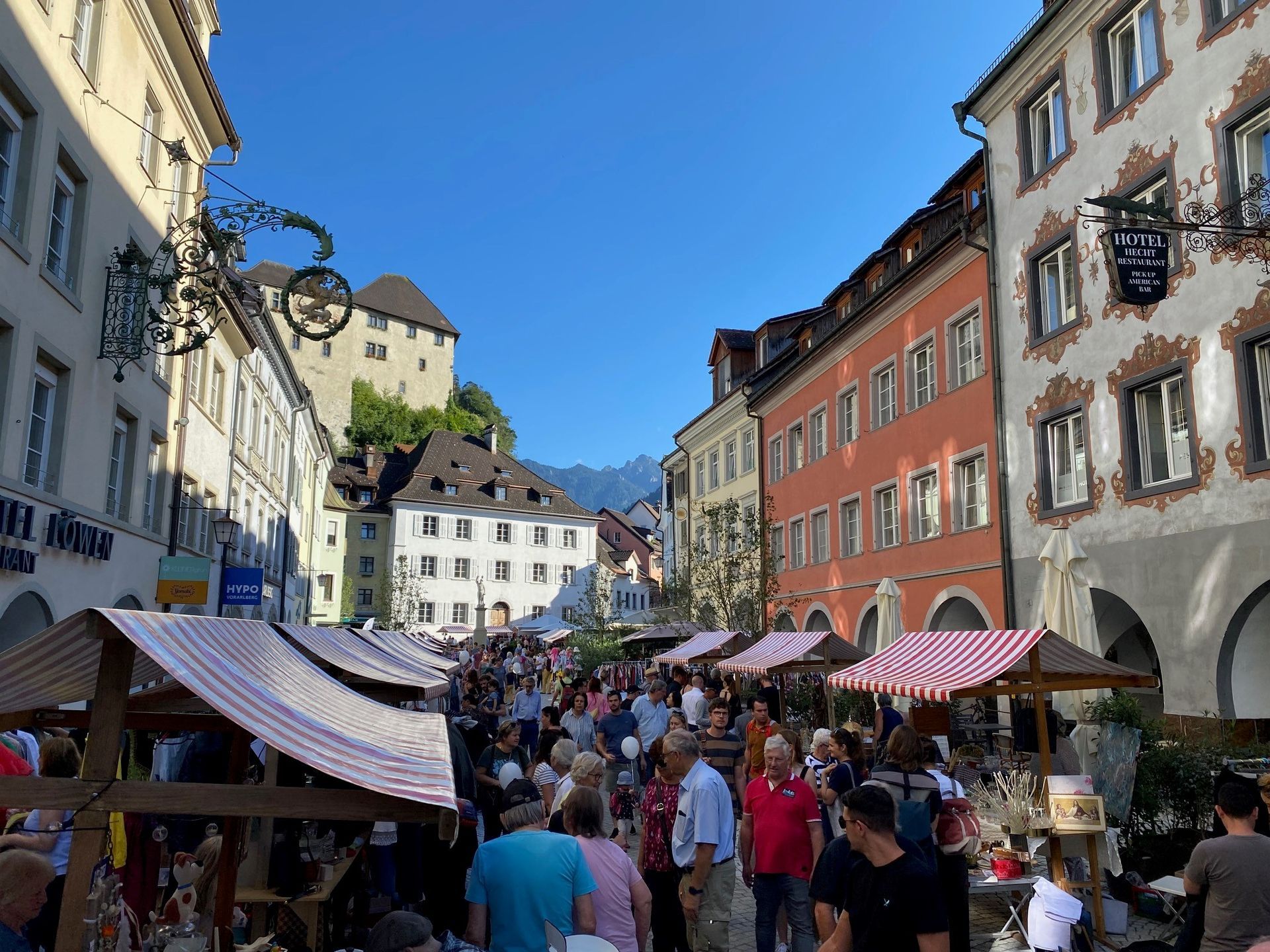 Eine Menschenmenge geht eine Straße in einer Stadt entlang