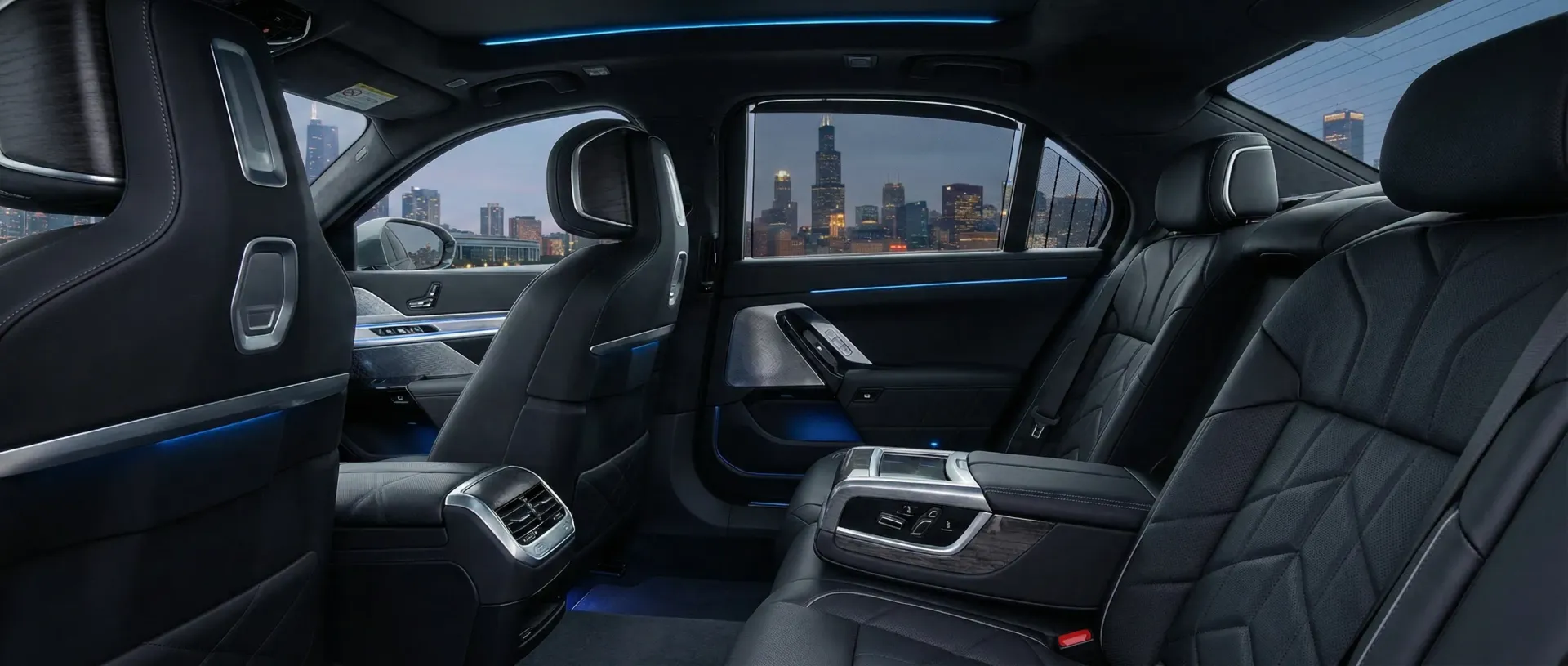 Interior of a BMW 7-Series with dark leather seats, modern climate controls, and a city skyline view through the window.