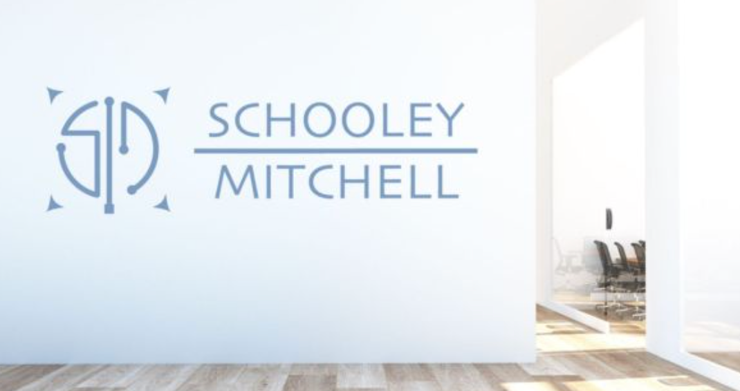 Sign for Schooley Mitchell franchise on a wall