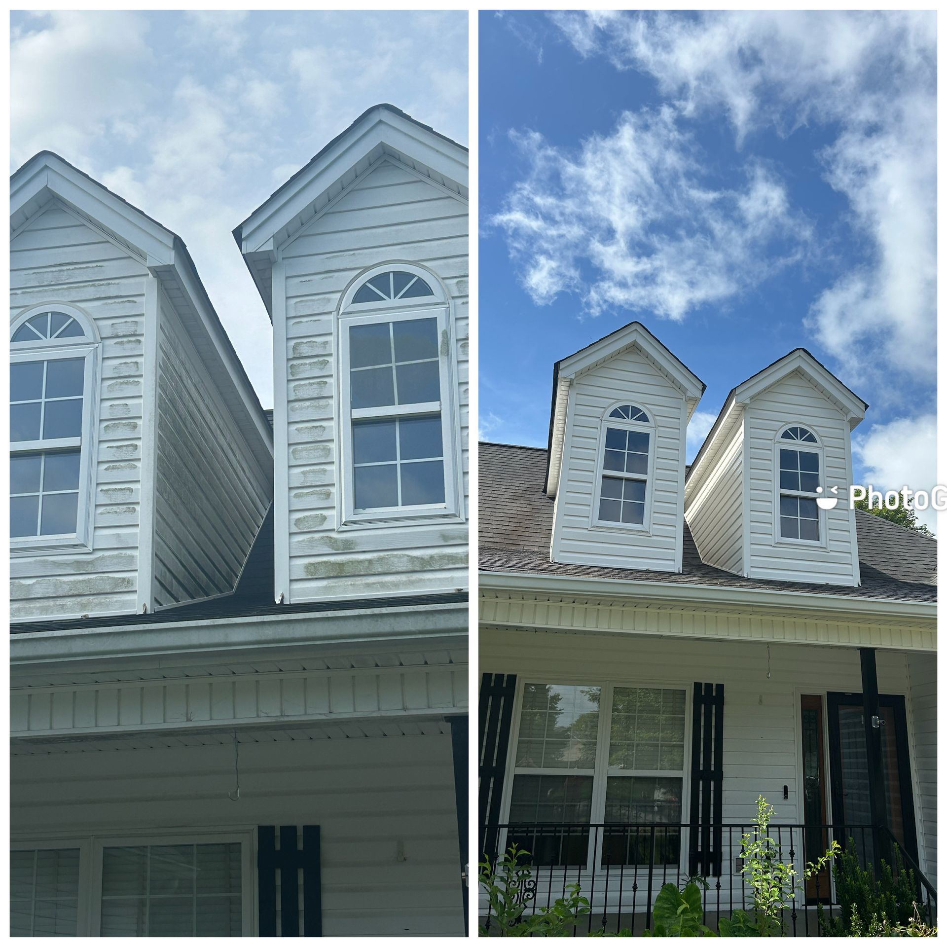Twin dormer windows on a house roof beneath a bright blue, partly cloudy sky.