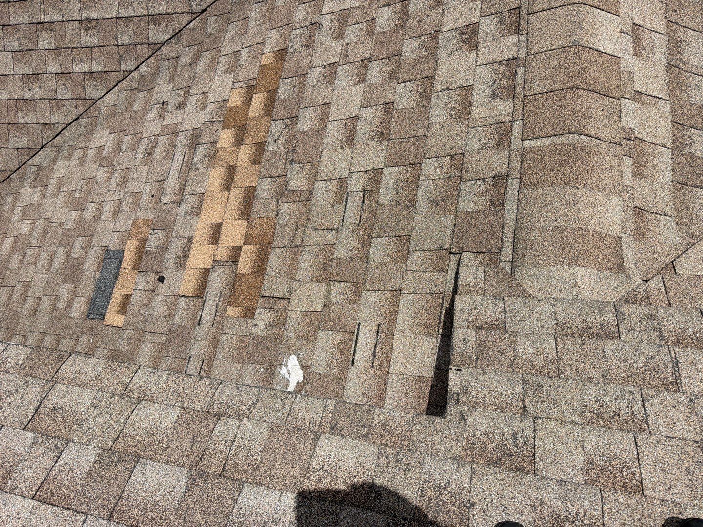 Wider view of an original 2004 shingle roof in Zephyrhills showing deterioration across multiple areas, demonstrating why replacement may be more appropriate than localized repairs on an aging roofing system.