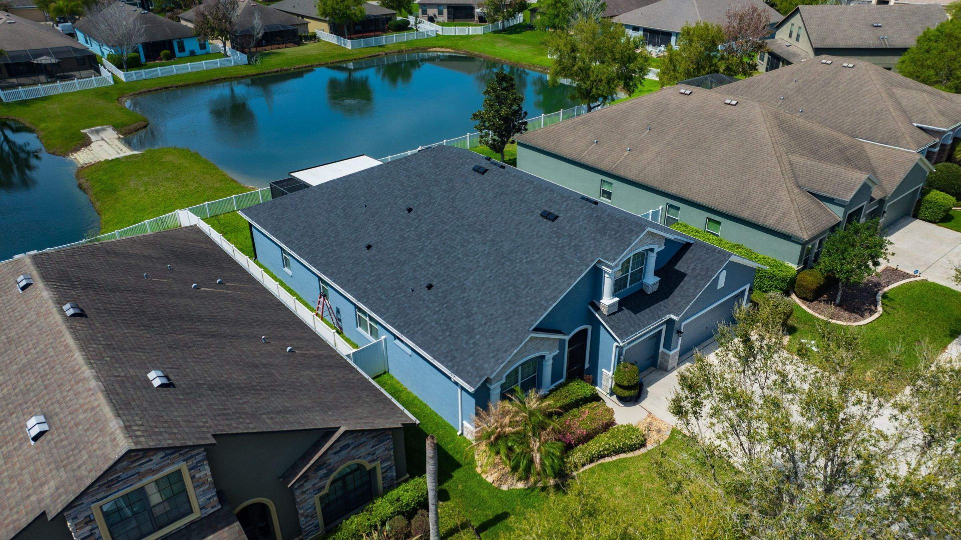 Aerial view of a newly installed CertainTeed Landmark Charcoal Black shingle roof on a residential home in Wesley Chapel, FL.