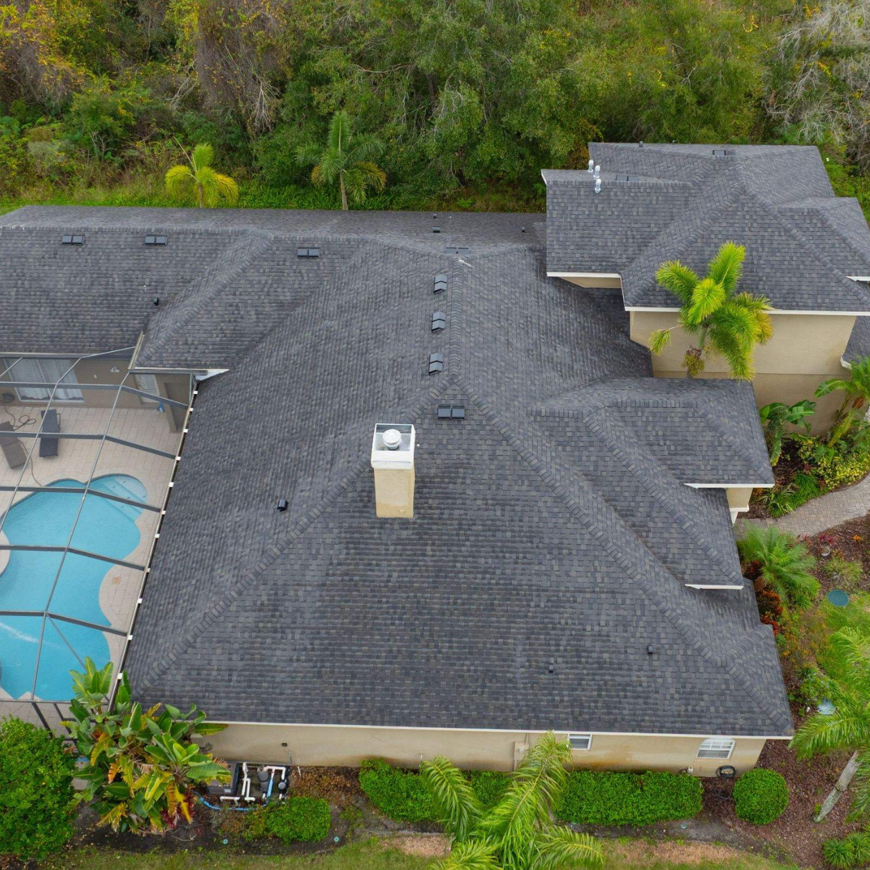 Overhead drone photo showing a new CertainTeed Landmark Espresso shingle roof installed after removing an old tile roof in Lutz, Florida.
