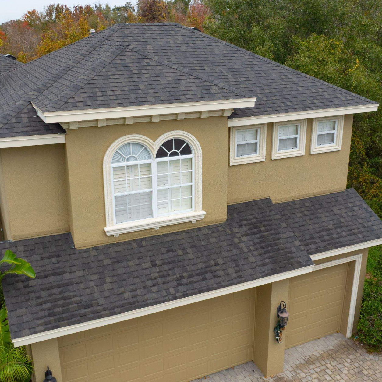 Close aerial view of a newly installed CertainTeed Landmark Espresso architectural shingle roof on a two-story home in Lutz, Florida.