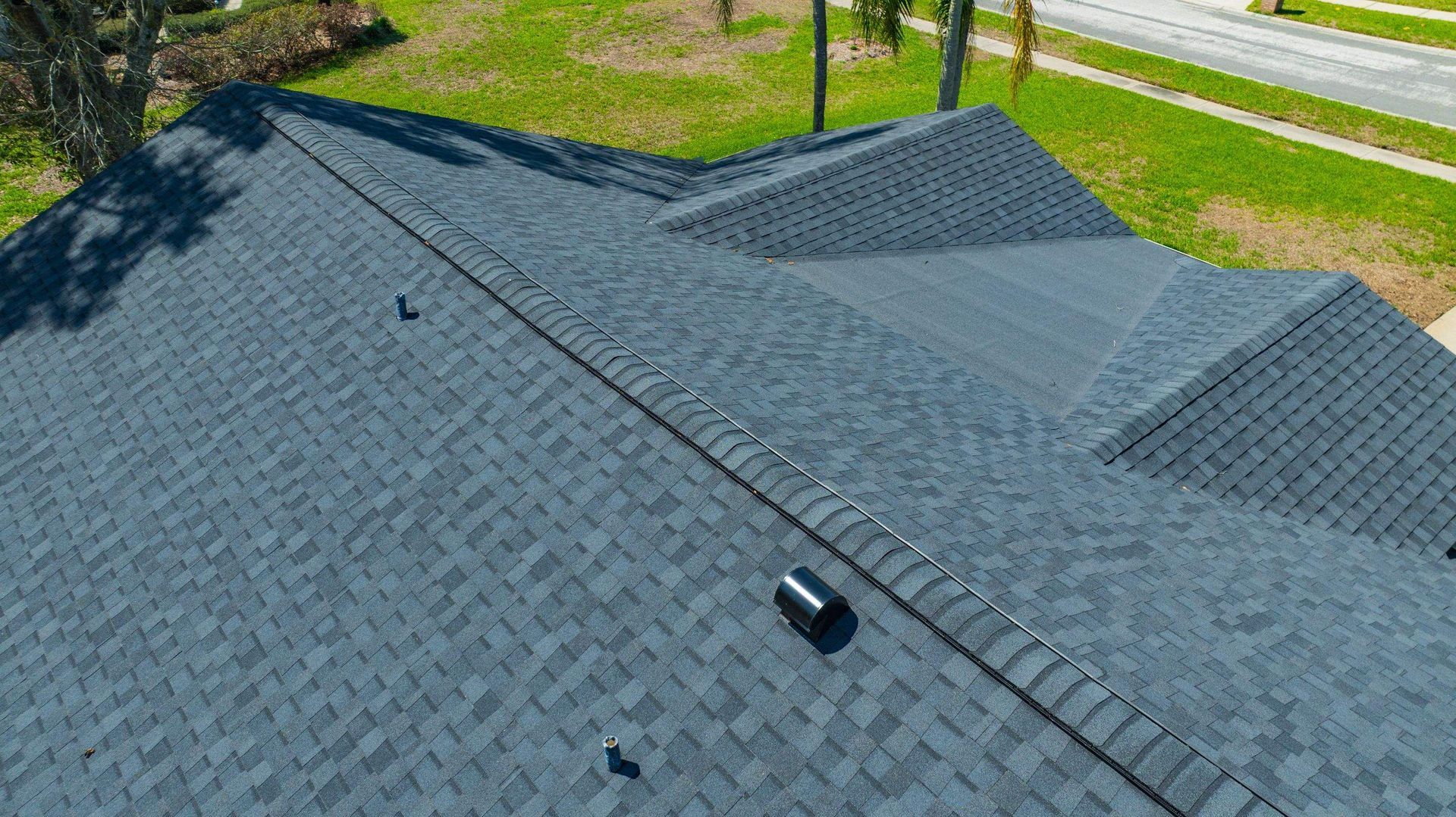 Overhead drone view of a CertainTeed Landmark Moire Black architectural shingle roof installed in Hammock Woods, Odessa, Florida.