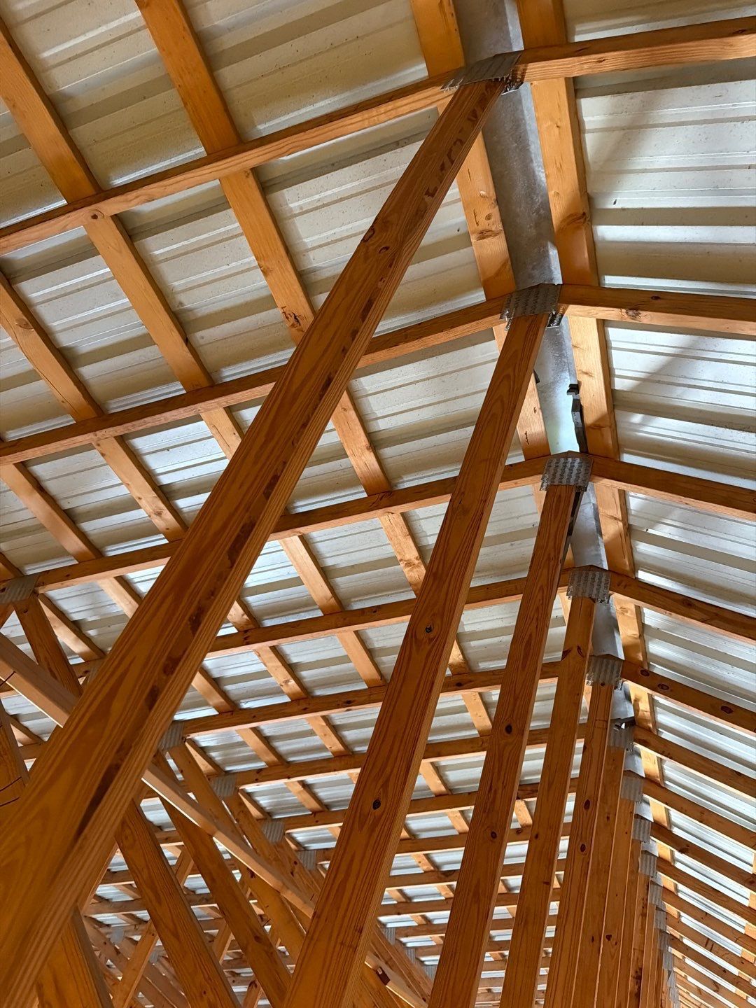 Interior view of the metal roofing system during inspection of a roof leak at a Dade City property.