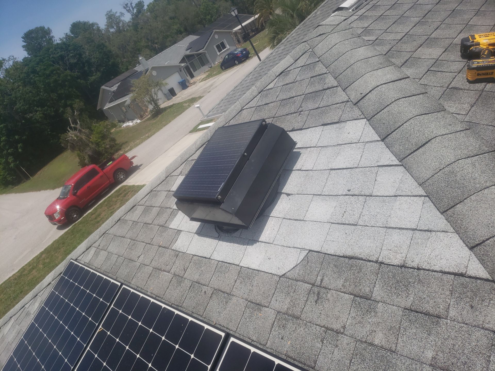 Powered attic ventilation fan installed on a shingle roof in Spring Hill, Florida