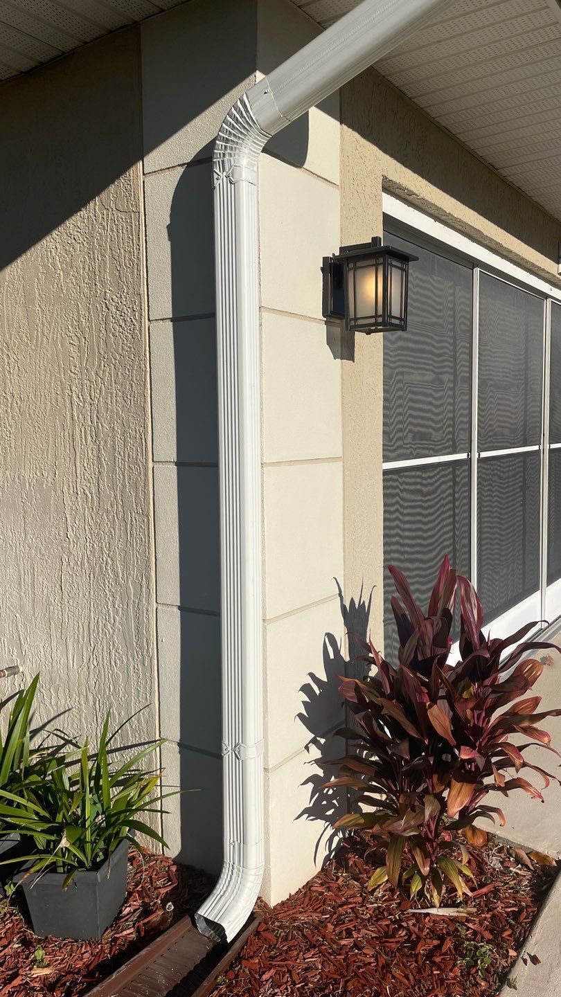 New white seamless gutter installation completed with roof replacement in San Antonio, FL.