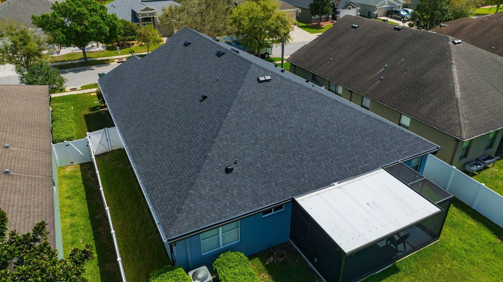 Aerial view of a CertainTeed Landmark Charcoal Black asphalt shingle roof replacement in Oak Creek HOA Wesley Chapel, FL.