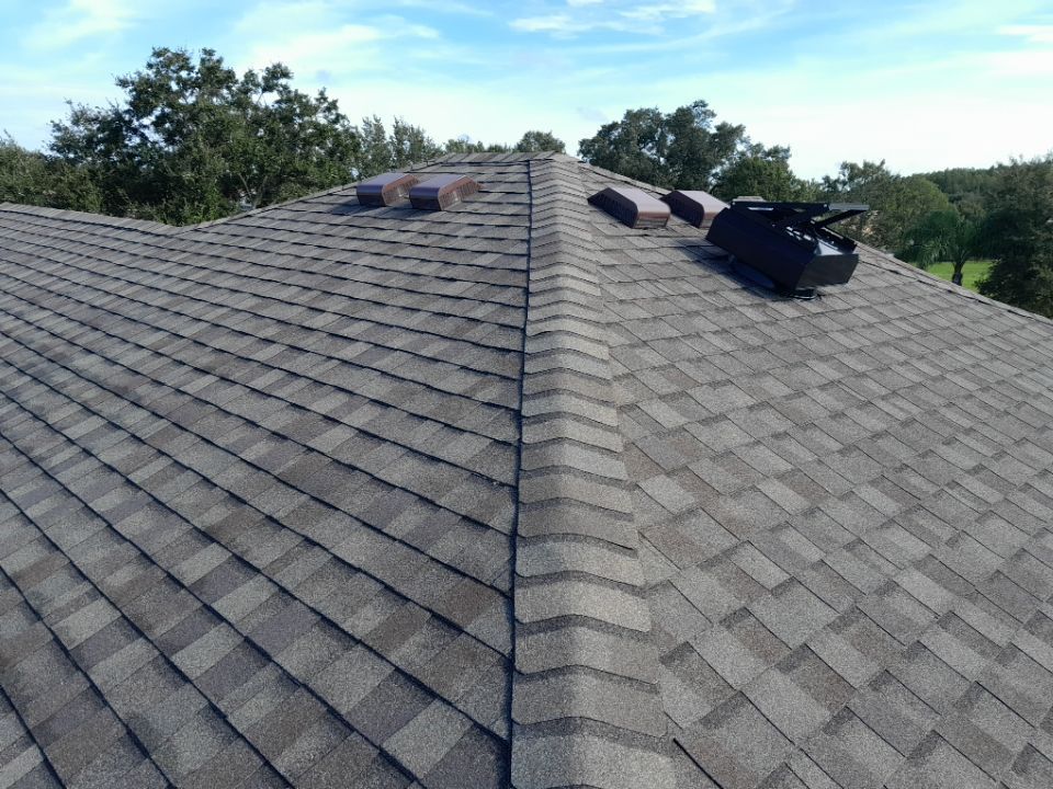 Solar-powered attic fan installed during a shingle roof replacement in Land O’ Lakes, Florida