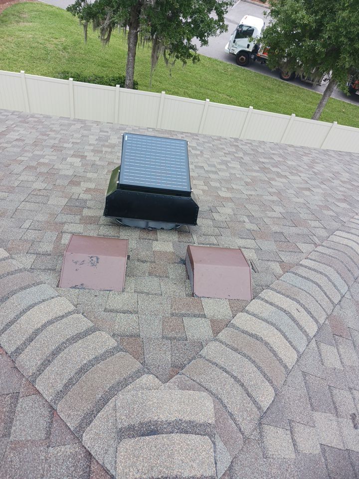 Close-up of solar-powered attic ventilation fan installed on a Florida shingle roof