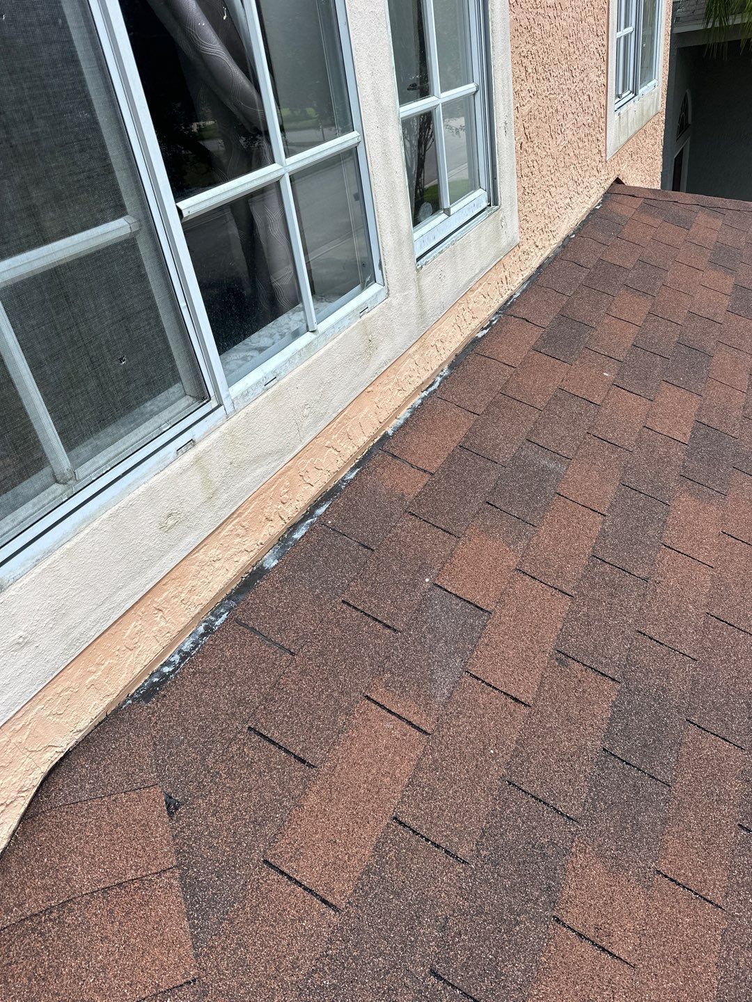 Head wall flashing repair on an asphalt shingle roof in Wesley Chapel, FL after a roof leak inspection