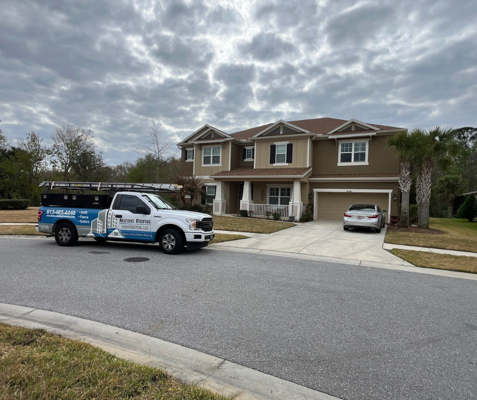 Nations Roofing & Construction LLC service truck in front of a residential home in Wesley Chapel FL
