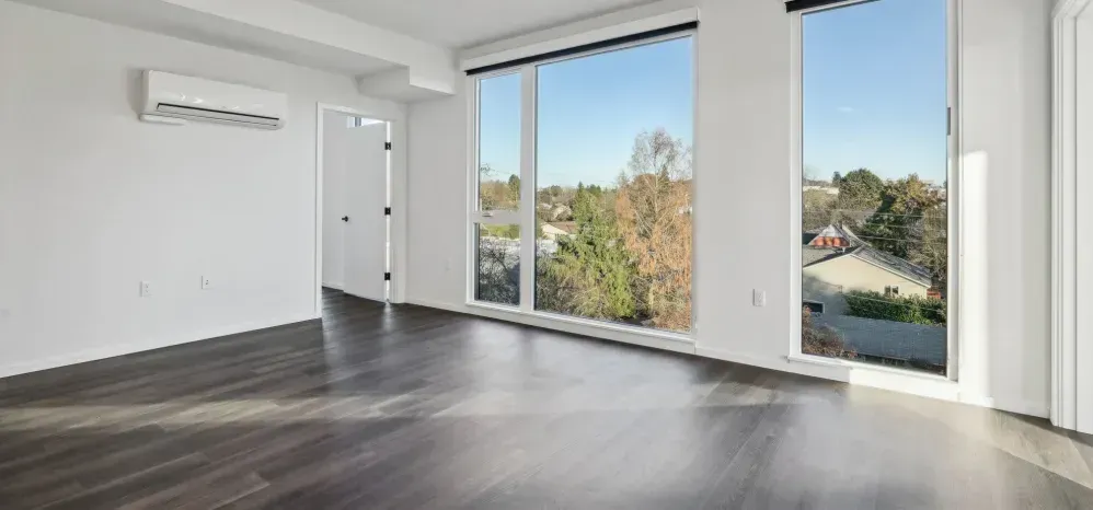 Photo showing a large living room with plenty of natural light and open space