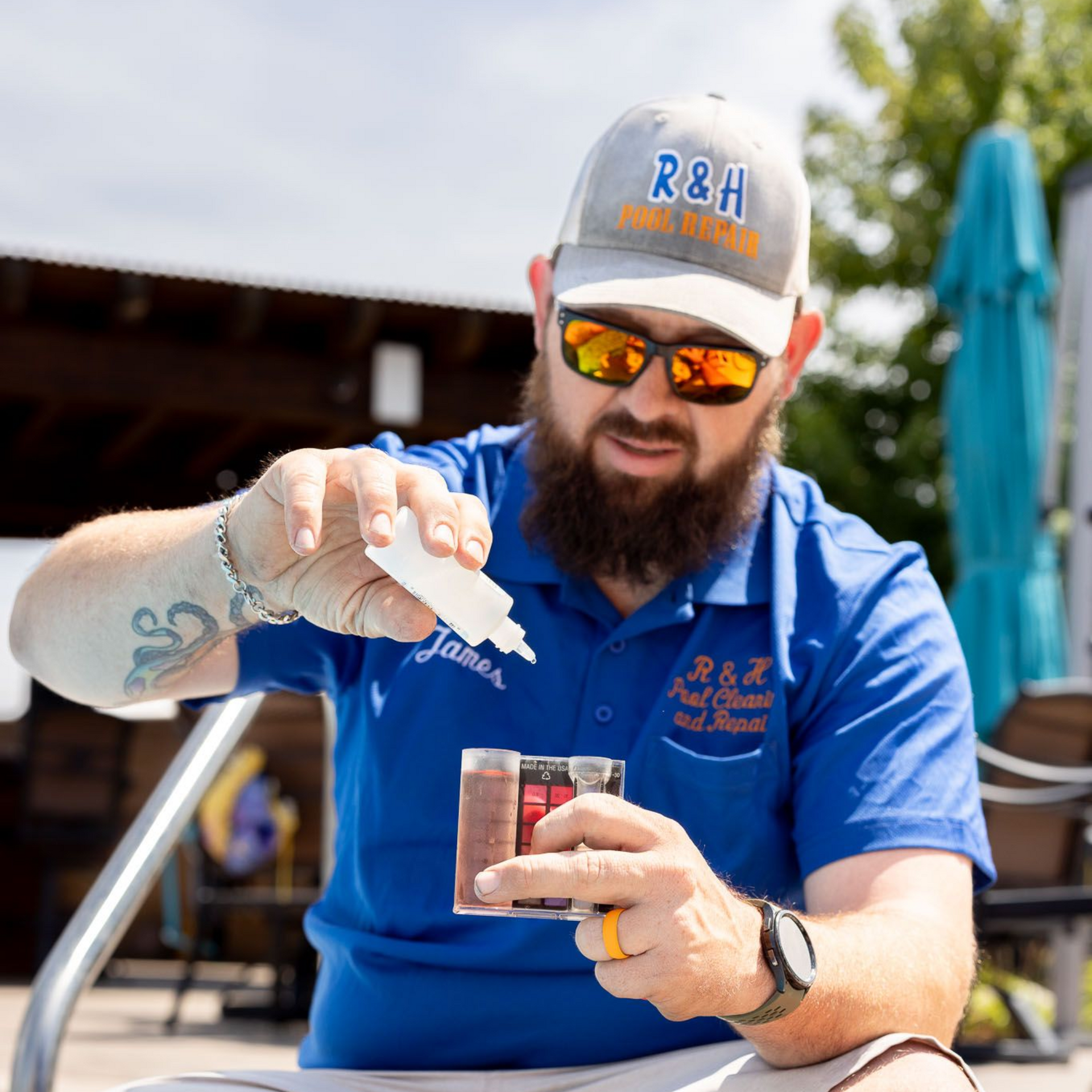 R&h Pool employee is testing the water in a swimming pool.