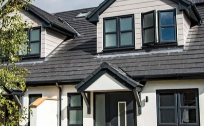 Modern house exterior with dark gray roof, white walls, and black-framed windows