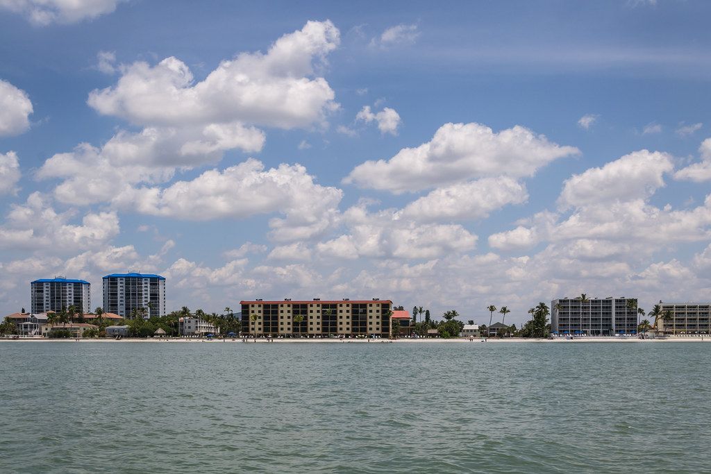 A view of a city from across the water on a cloudy day.