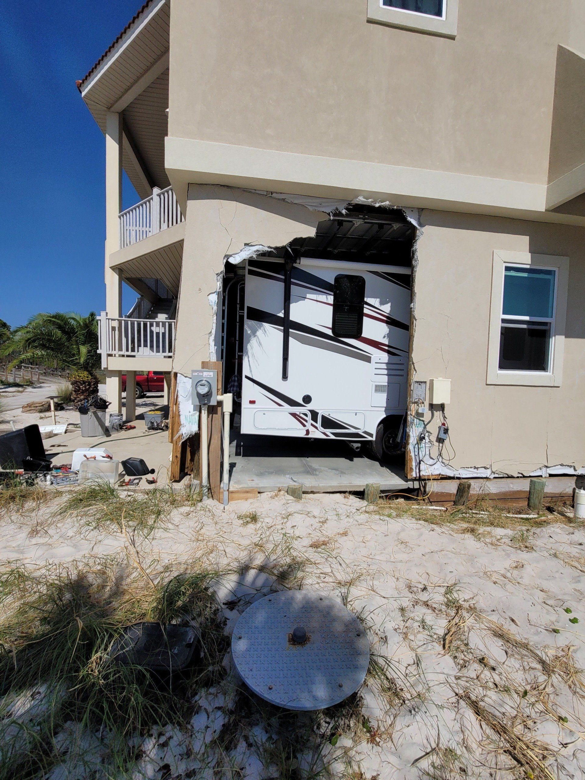 A rv is parked in the garage of a house