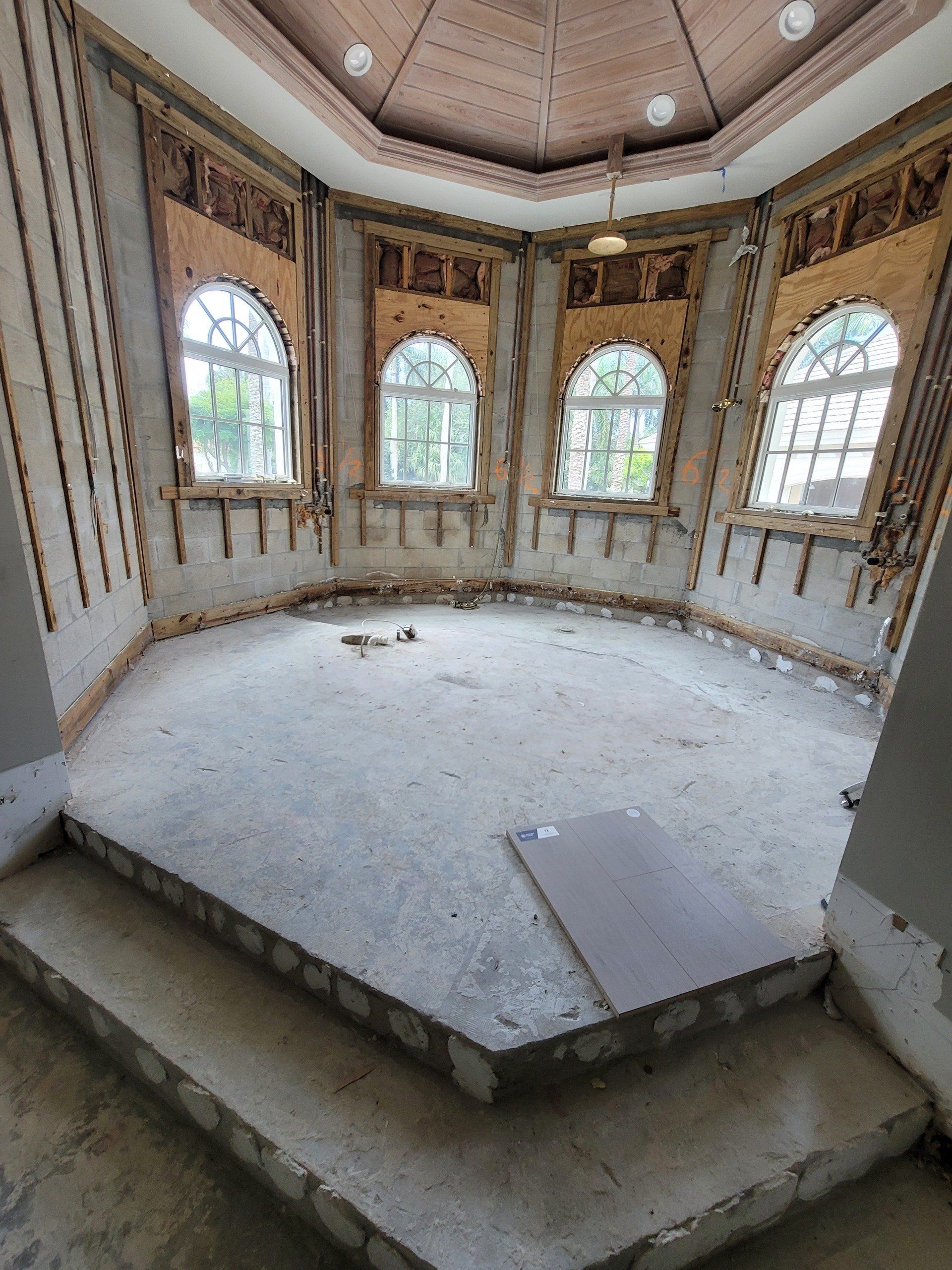 An empty room with a lot of windows and stairs