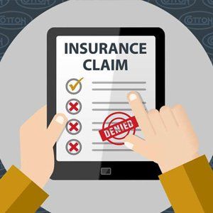 A person is holding a tablet with an insurance claim on it