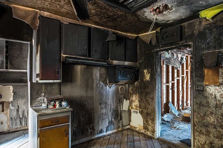 A kitchen that has been damaged by a fire.