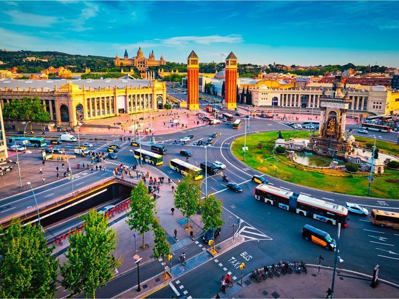 Vista aérea de la Plaza de España de Barcelona con tráfico, edificios y las Torres Venecianas.