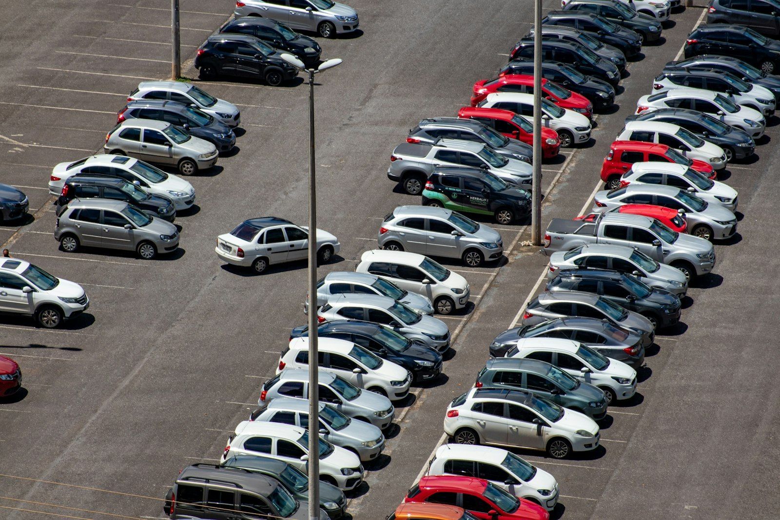 Aerial view of a parking lot filled with used cars