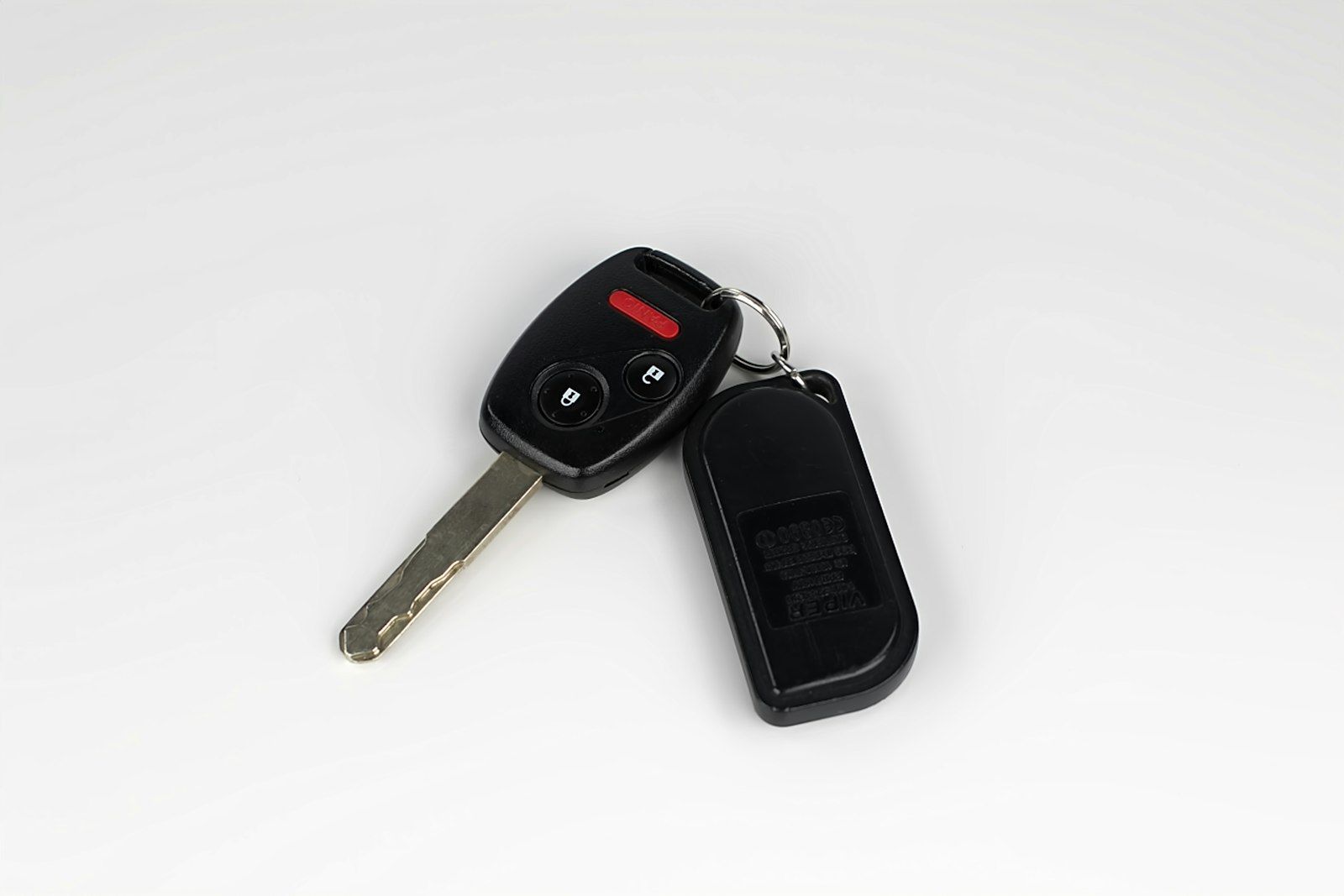 Car key and remote fob on a white background