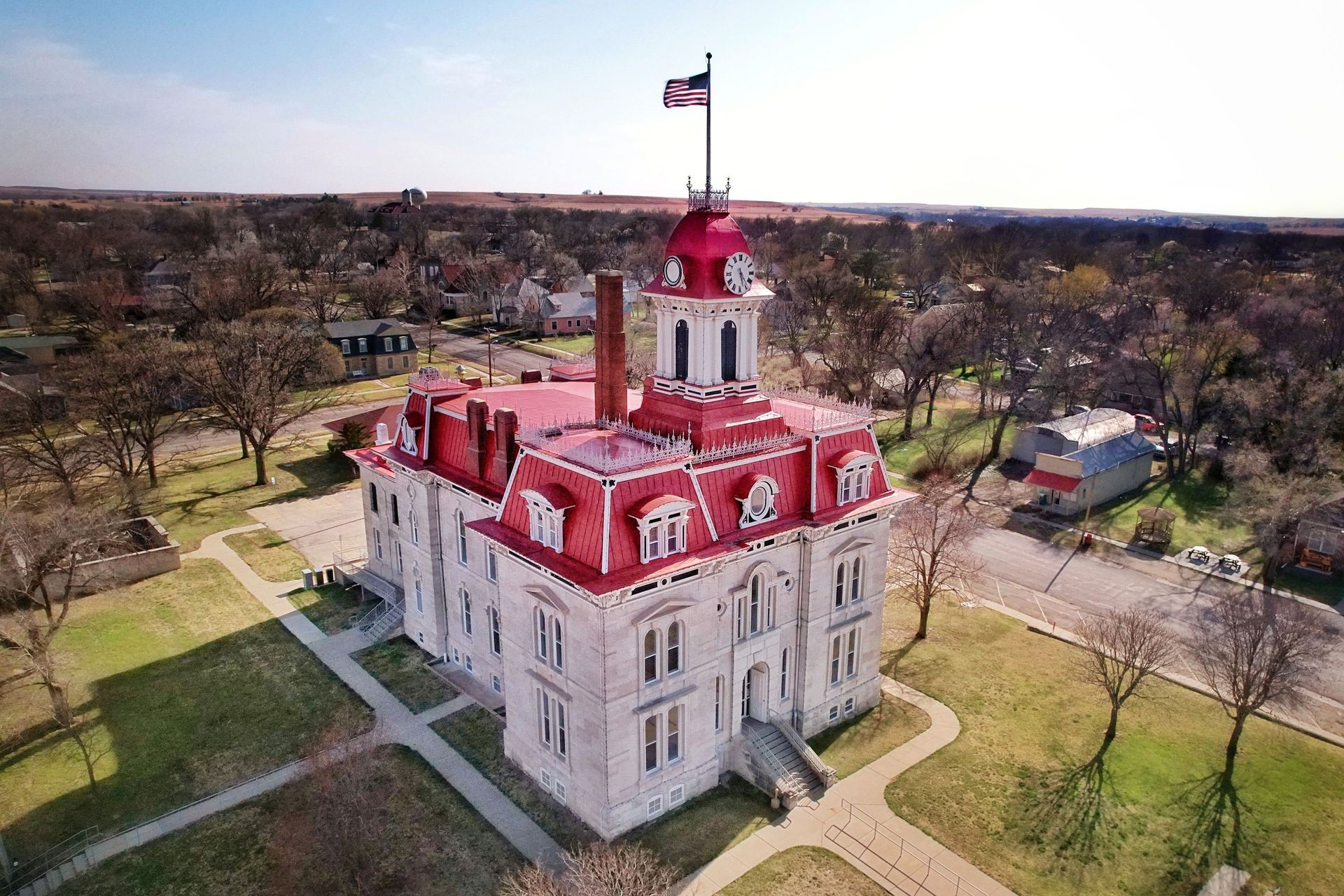 Aerial view of the historic Chase County Courthouse with its red roof in Cottonwood Falls, Kansas