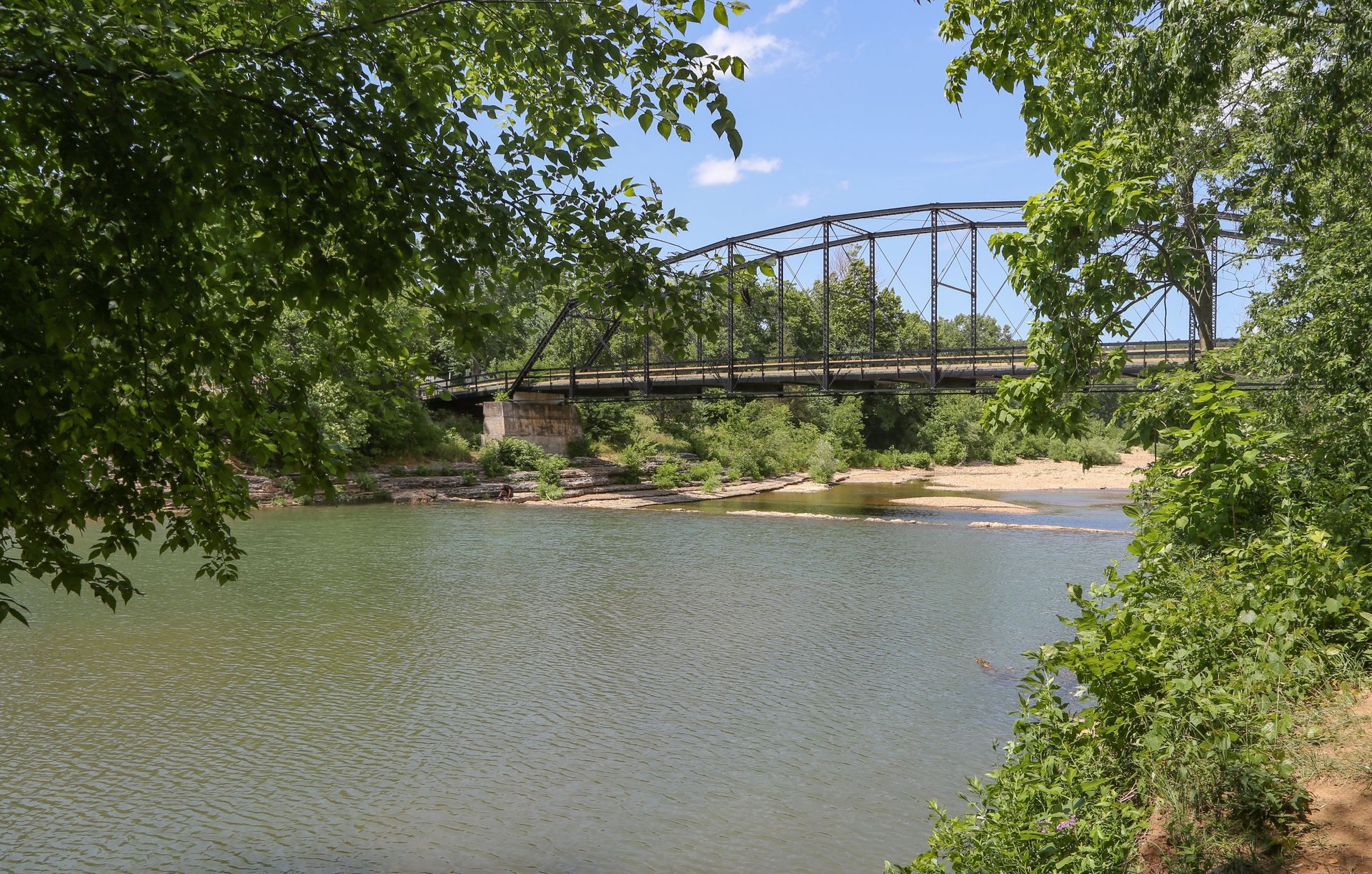 The historic steel truss War Eagle Bridge crossing the War Eagle River in Rogers, Arkansas