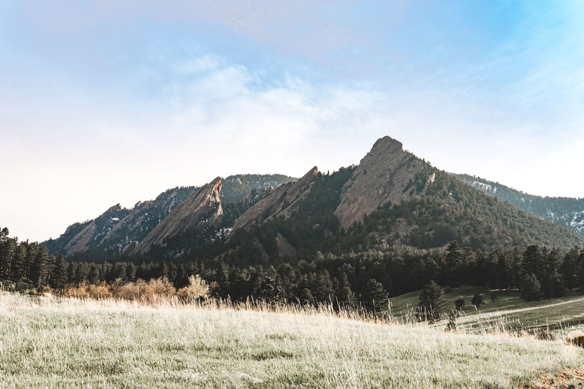 The iconic slanted sandstone rock formations of the Flatirons rising above Boulder, Colorado