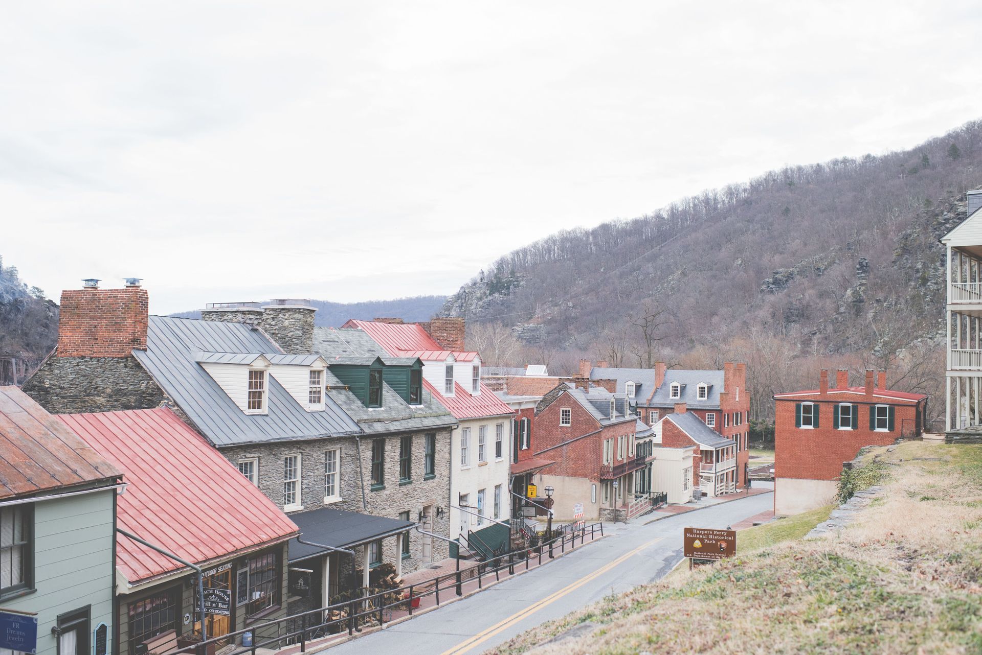 The historic brick and stone buildings of Harpers Ferry Lower Town along the road in West Virginia.