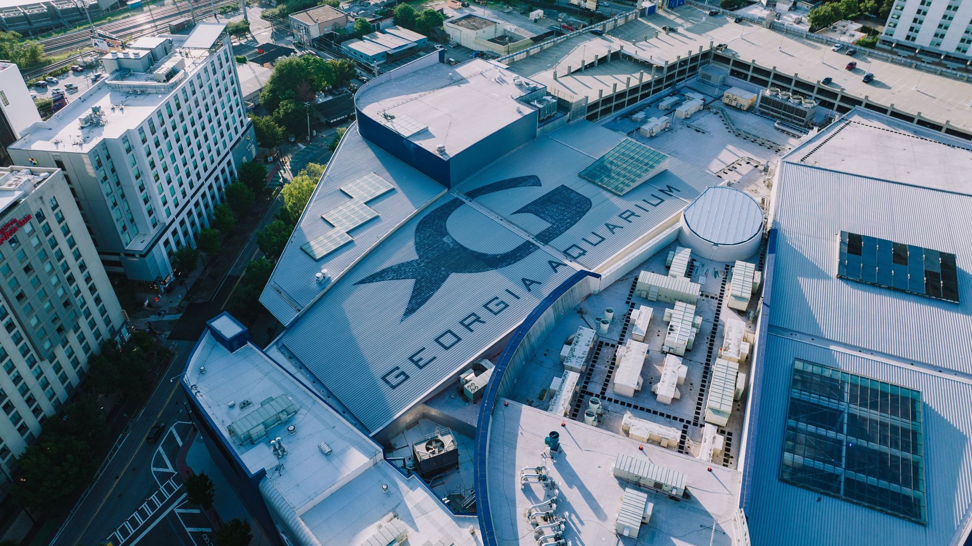 Aerial drone view of the iconic Georgia Aquarium rooftop in downtown Atlanta, Georgia