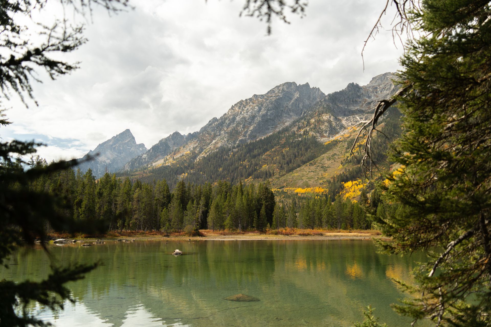 The majestic Teton Range reflecting on the calm waters of String Lake in Grand Teton National Park, Wyoming.