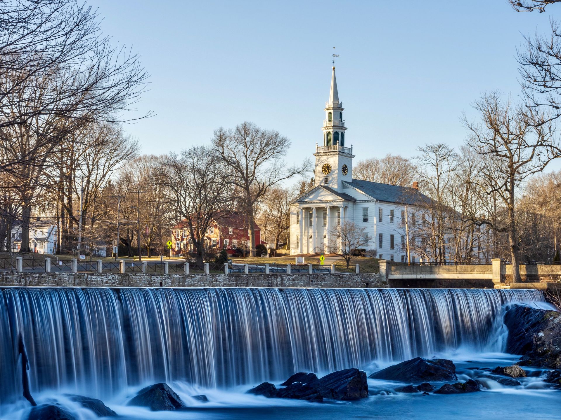 Scenic Wepawaug River waterfall and the historic First Congregational Church in Milford, Connecticut
