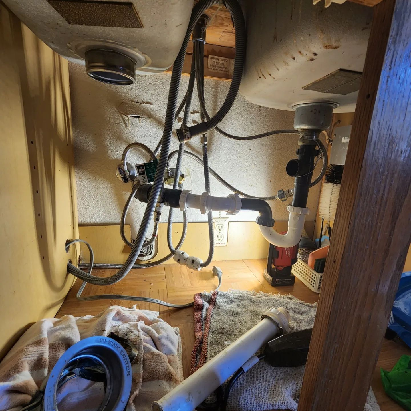 A sink with a lot of wires coming out of it
