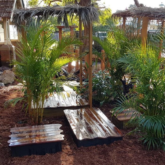 A Wooden Bench is Sitting in the Middle of a Garden — Garden Vogue in Lake Macquarie, NSW