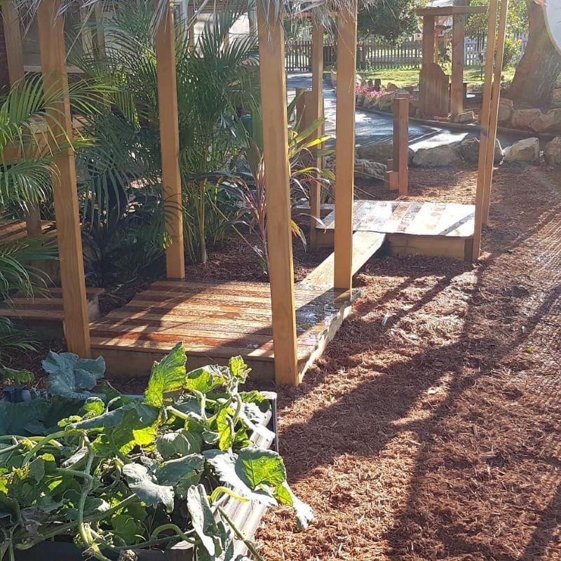 A Wooden Structure in the Middle of a Garden Surrounded by Plants — Garden Vogue in Lake Macquarie, NSW