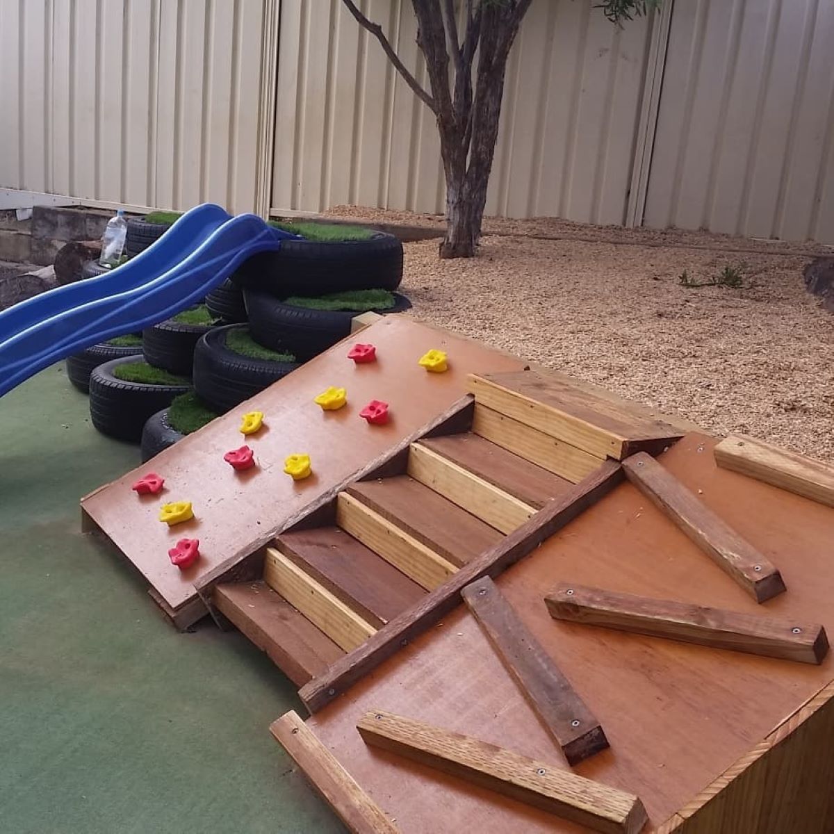 A Wooden Playground With a Slide and Stairs — Garden Vogue in Charlestown, NSW