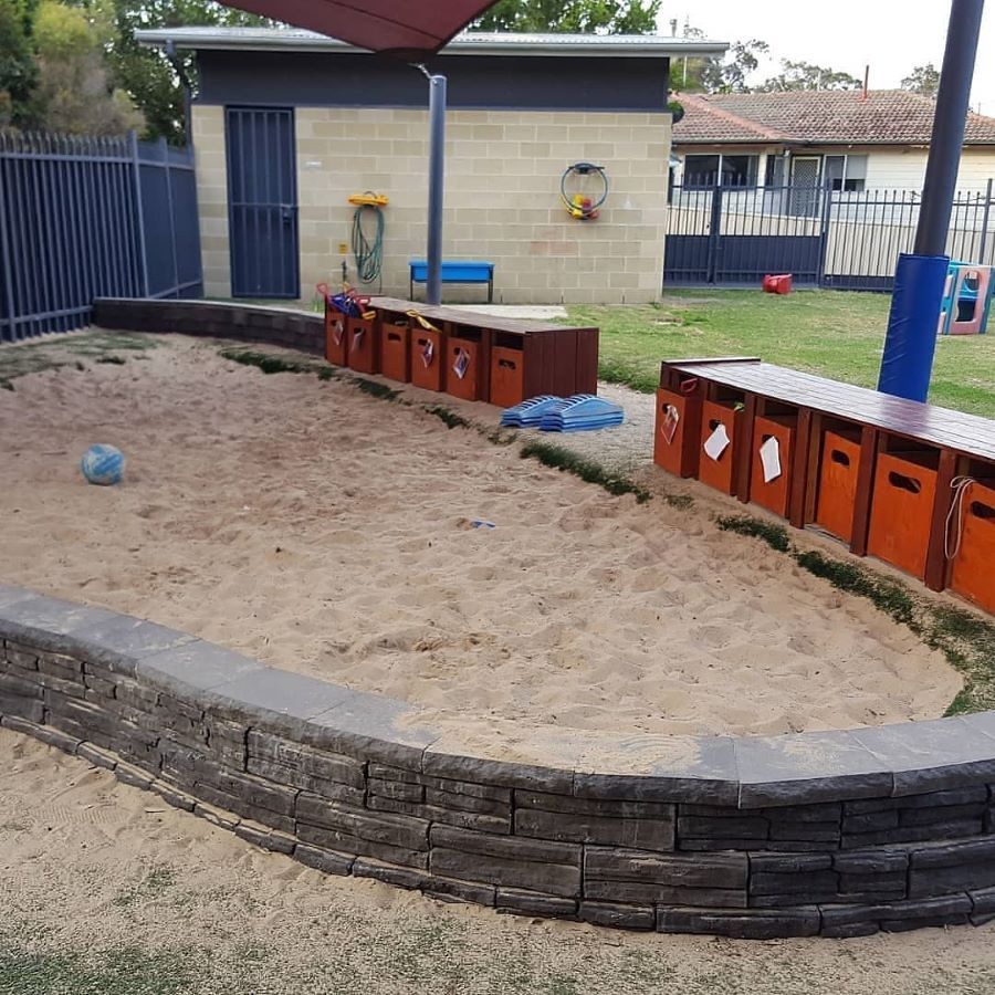 A Sandbox With a Brick Wall Surrounding It — Garden Vogue in Lake Macquarie, NSW