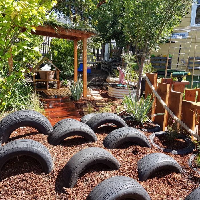 A Bunch of Tires Are Stacked on Top of Each Other in a Garden — Garden Vogue in Charlestown, NSW