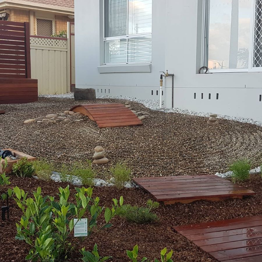 A Garden With a Wooden Walkway Leading to a House — Garden Vogue in Charlestown, NSW