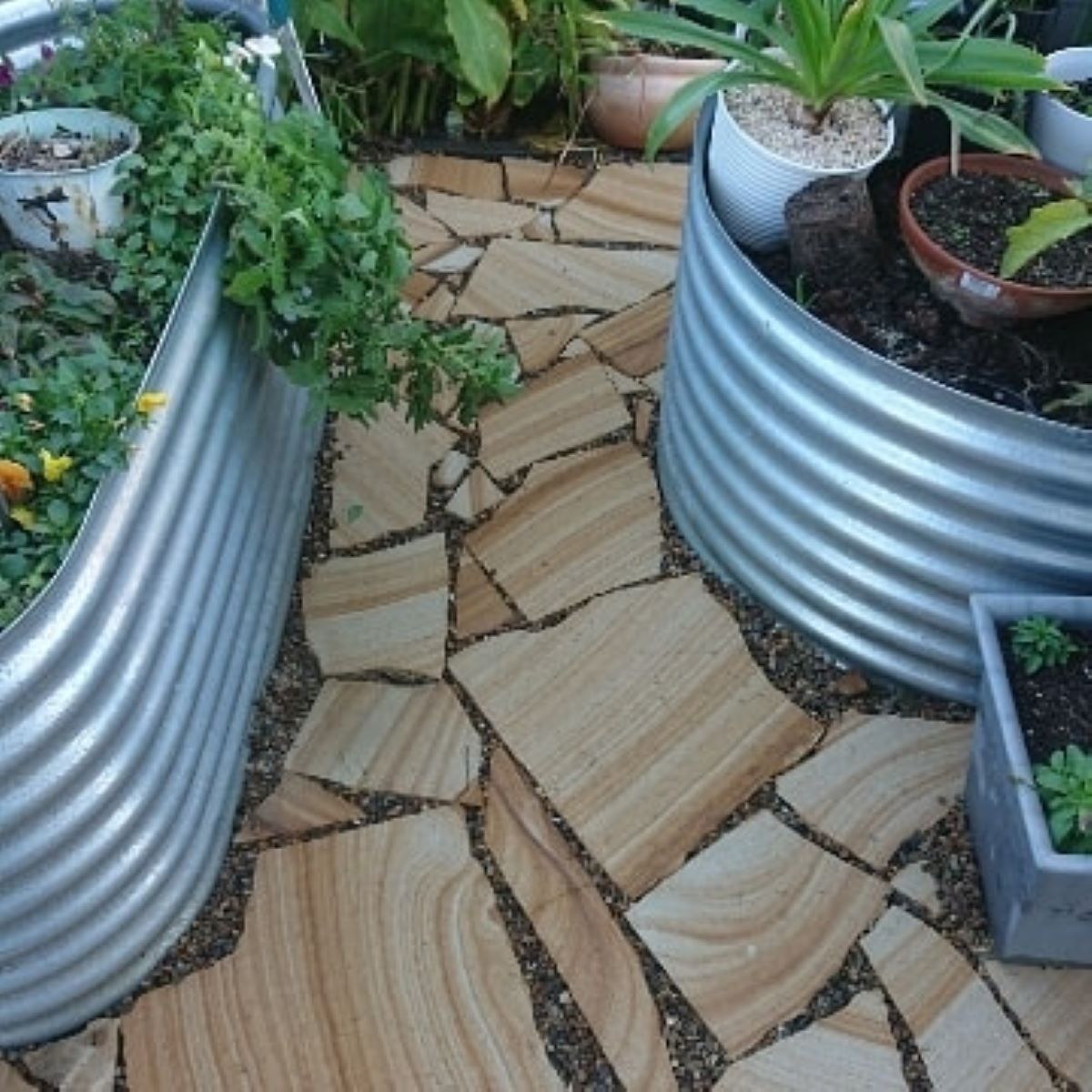 A Row of Metal Planters Filled With Potted Plants — Garden Vogue in Lake Macquarie, NSW