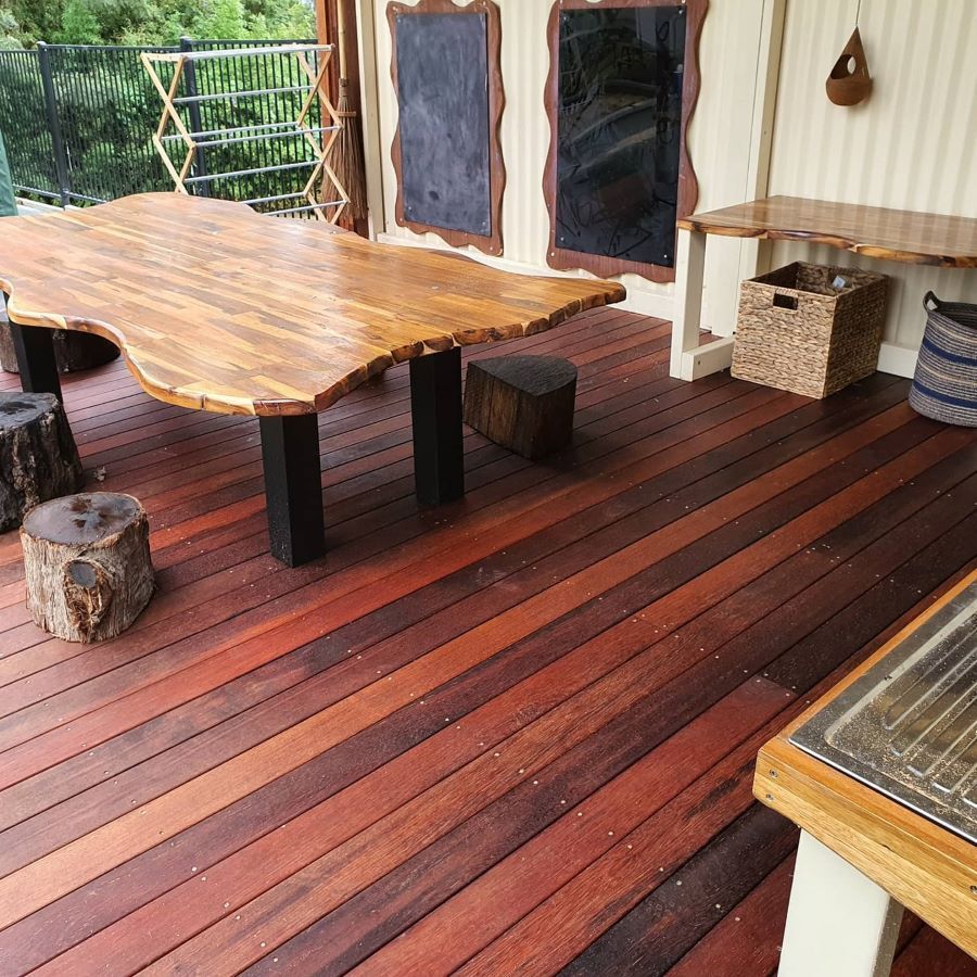 A Wooden Deck With a Large Wooden Table and Stools — Garden Vogue in Charlestown, NSW